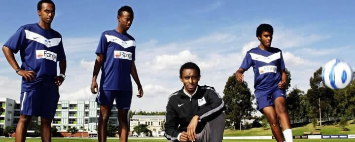 Dini, in front of players on the team he formed in Australia